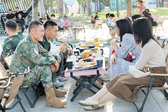 參加活動的軍地男女青年進行互動。
