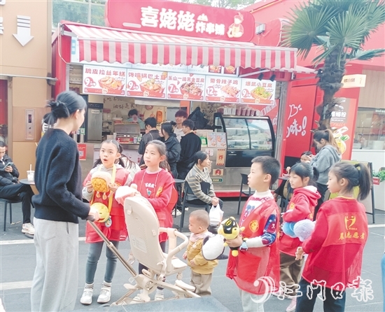 統(tǒng)一身著志愿者服裝的孩子們化身“愛(ài)心小掌柜”，向顧客推銷(xiāo)商品。