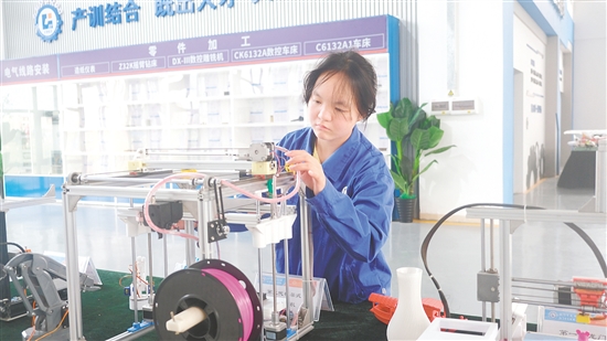 馮曉熒在操作3D打印機(jī)。